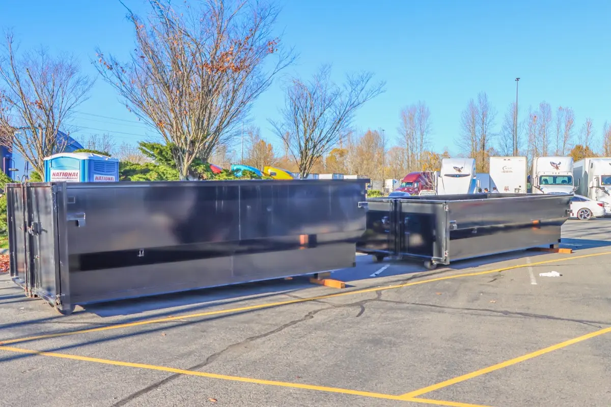 Professional dumpster rental service with roll-off container on residential driveway in Kirksville
